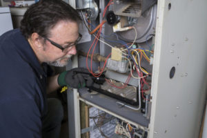 Vigilant Man Inspecting Furnace Shutterstock 323101256