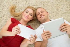 Couple Holding Electronics For Wi