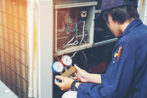 Technician Is Checking Air Conditioner In Factory