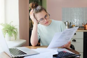 Girl Looking At Energy Bills